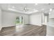 Bright living room with a ceiling fan and sliding doors to the backyard at 4613 Madison Ave, Lake Wales, FL 33859