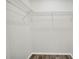A very simple walk-in closet with installed wired racks and laminate floors at 4613 Madison Ave, Lake Wales, FL 33859