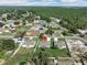 Aerial view of three single-Gathering homes featuring green lawns, driveways, and fenced yards in a serene, wooded neighborhood at 4615 Madison Ave, Lake Wales, FL 33859