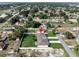 An aerial shot displays three properties with green lawns and privacy fences, nestled in a neighborhood with mature trees at 4615 Madison Ave, Lake Wales, FL 33859
