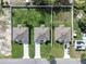 An aerial shot showcases three adjacent homes with matching roofs, driveways, and fenced yards, side by side at 4615 Madison Ave, Lake Wales, FL 33859