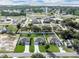 Aerial view of three homes with well-manicured lawns, driveways, and mature trees in a neighborhood near the water at 4615 Madison Ave, Lake Wales, FL 33859