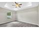 This bedroom features stylish gray flooring, a ceiling fan, and recessed lighting at 4615 Madison Ave, Lake Wales, FL 33859