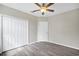 Bedroom featuring hard floors, a ceiling fan, and a closet at 4615 Madison Ave, Lake Wales, FL 33859