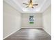 This bedroom features stylish gray flooring, a ceiling fan, and recessed lighting at 4615 Madison Ave, Lake Wales, FL 33859