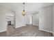 Dining room showcasing archways, new flooring, and views into kitchen and living room at 4615 Madison Ave, Lake Wales, FL 33859
