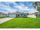 Charming single-story home featuring a well-manicured lawn and a classic two-car garage at 4615 Madison Ave, Lake Wales, FL 33859