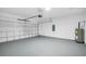 This garage has an automatic door, water heater, and gray epoxy floor at 4615 Madison Ave, Lake Wales, FL 33859