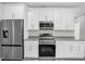 Modern kitchen with stainless steel appliances and white cabinetry at 4615 Madison Ave, Lake Wales, FL 33859