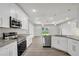Bright kitchen features white cabinets, stainless steel appliances, and granite countertops at 4615 Madison Ave, Lake Wales, FL 33859