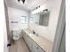 Modern bathroom with updated vanity, granite countertop, and a large mirror at 5249 Se 106Th Ln, Belleview, FL 34420
