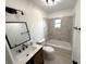Bright bathroom features marble tile, a sleek vanity, and a tub with shower at 5249 Se 106Th Ln, Belleview, FL 34420
