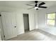 Cozy bedroom with a ceiling fan, closet, and a window allowing natural light at 5249 Se 106Th Ln, Belleview, FL 34420