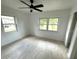 Cozy bedroom with plenty of natural light, a ceiling fan, and wood-look floors at 5249 Se 106Th Ln, Belleview, FL 34420
