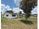 Quaint single-story home with white siding, black shutters, and a charming yard at 5249 Se 106Th Ln, Belleview, FL 34420