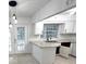 Bright kitchen with white cabinets, granite countertops, stainless steel sink and modern lighting at 5249 Se 106Th Ln, Belleview, FL 34420