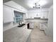 Modern kitchen with stainless steel appliances, granite countertops, and white cabinets at 5249 Se 106Th Ln, Belleview, FL 34420