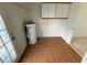 Practical laundry area featuring a water heater, storage cabinets, and access to outside at 5249 Se 106Th Ln, Belleview, FL 34420