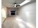 Spacious living room with a decorative brick fireplace, recessed lighting, and neutral paint at 5249 Se 106Th Ln, Belleview, FL 34420