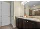 Bathroom featuring a double granite vanity, tiled shower, and neutral colors at 551 Lasso Dr, Kissimmee, FL 34747