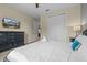 Bedroom with a mounted TV, closet and bright white bedding at 551 Lasso Dr, Kissimmee, FL 34747