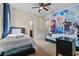 Bedroom with two beds, closet, and vibrant Frozen themed accent wall at 551 Lasso Dr, Kissimmee, FL 34747
