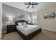 Comfortable bedroom with neutral paint, carpet, a queen bed, and mounted television at 551 Lasso Dr, Kissimmee, FL 34747