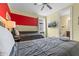 Bedroom with two beds, a window, mounted TV, and fun red accent wall at 551 Lasso Dr, Kissimmee, FL 34747