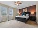 Inviting bedroom features natural light, a ceiling fan, and dark wood furniture at 551 Lasso Dr, Kissimmee, FL 34747