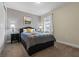 Comfortable bedroom showcasing a queen bed, nightstands with lamps, and a window at 551 Lasso Dr, Kissimmee, FL 34747