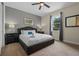 Bright bedroom featuring a queen bed, ceiling fan, and large window at 551 Lasso Dr, Kissimmee, FL 34747