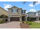 Charming two-story home features a two-car garage and a meticulously maintained lawn at 551 Lasso Dr, Kissimmee, FL 34747