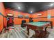 Spacious game room with arcade games, TVs, and a pool table, perfect for entertainment at 551 Lasso Dr, Kissimmee, FL 34747