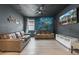 Home theater room with leather couches, a large mural, and a ceiling fan at 551 Lasso Dr, Kissimmee, FL 34747
