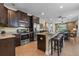 Eat-in kitchen featuring stainless steel appliances, a center island, and dark wood cabinetry at 551 Lasso Dr, Kissimmee, FL 34747