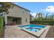 An inviting private pool area with pavers, a spa, outdoor dining and a privacy fence at 551 Lasso Dr, Kissimmee, FL 34747