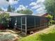Backyard with screen porch and paver patio, a step stool, and various landscaping features at 6478 Inca St, Orlando, FL 32807