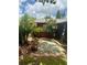 Backyard with concrete paver, flower pots and various colorful plants and bushes with pink flowers at 6478 Inca St, Orlando, FL 32807