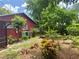 Backyard featuring a house and a variety of colorful landscaping with a mix of plants and bushes at 6478 Inca St, Orlando, FL 32807