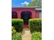 Inviting front entrance featuring a dark double door, archways, and well-manicured bushes at 6478 Inca St, Orlando, FL 32807