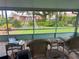 View from the screened-in porch with tile flooring, patio furniture, and an outside view of the yard at 6478 Inca St, Orlando, FL 32807