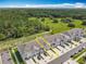 Aerial view of townhomes nestled next to green space, highlighting a serene location at 7685 Stone Creek Trl, Kissimmee, FL 34747