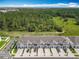 Aerial view of townhomes surrounded by lush trees, showcasing community living at 7685 Stone Creek Trl, Kissimmee, FL 34747