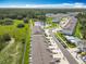Aerial view of the community, featuring a pond, swimming pool, and green spaces at 7685 Stone Creek Trl, Kissimmee, FL 34747