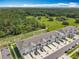 Aerial view of townhomes nestled next to green space, highlighting a serene location at 7685 Stone Creek Trl, Kissimmee, FL 34747