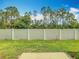 View of the backyard showcasing green grass and a white fence at 7685 Stone Creek Trl, Kissimmee, FL 34747