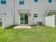 View of the backyard with a sliding glass door to the interior at 7685 Stone Creek Trl, Kissimmee, FL 34747
