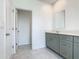 Bathroom featuring vanity with gray cabinets, quartz countertop, and open doorway at 7685 Stone Creek Trl, Kissimmee, FL 34747
