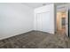 Bedroom with neutral carpet, double door closet, and doorway to another room at 7685 Stone Creek Trl, Kissimmee, FL 34747