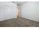 Bedroom with neutral carpet, double door closet, and view into adjoining space at 7685 Stone Creek Trl, Kissimmee, FL 34747